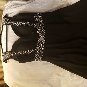 Elegant long jeweled black sleeveless evening gown.